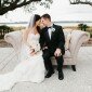 bride and groom pose with couch
